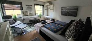 a bedroom with a bed and a desk in it at Villa Sommersted Andersen in Sommersted