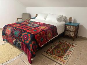 a bedroom with a bed and a nightstand with a bed sidx sidx at Casa Alento in Yzerfontein