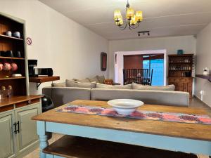 a living room with a table and a couch at Casa Alento in Yzerfontein