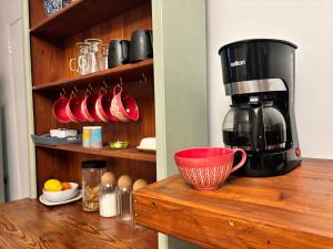 a coffee maker sitting on top of a wooden counter at Casa Alento in Yzerfontein +73 photos