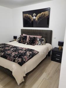 a bedroom with a bed with angel wings on the wall at Valle du mezzane in Valle-di-Mezzana