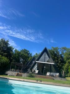 a house shaped like a pyramid with a swimming pool at Les Angères in Saint-Martin-d'Uriage