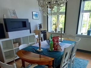 a dining room table with a blue table cloth on it at Villa Sommersted Andersen in Sommersted +11 photos