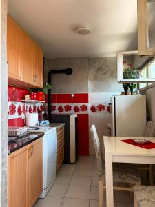a kitchen with a white refrigerator and red walls at Stan na dan in Pljevlja