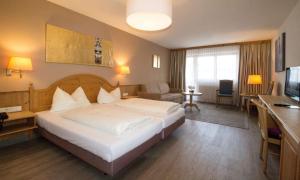 a hotel room with a bed and a living room at Hotel Munde in Telfs