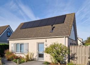 a house with solar panels on the roof of it at Grevelingen 24 Ouddorp in Ouddorp