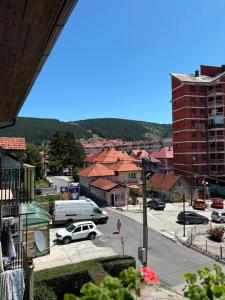 a view of a city with cars parked in a parking lot at Stan na dan in Pljevlja