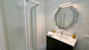 a bathroom with a sink and a shower with a mirror at The Yellow Corner in Pasian di Prato +15 photos