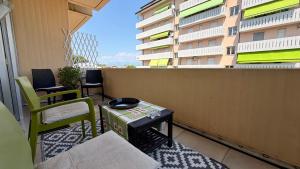 a balcony with a table and chairs and a building at The Yellow Corner in Pasian di Prato
