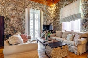 a living room with two couches and a table at Seaview stone apartment in Ipsos Beach in Ipsos