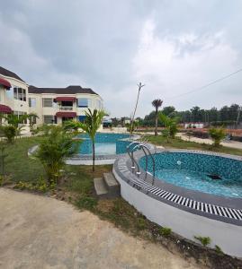 a swimming pool in front of a house at Parinay Pavilion LLP in Bahraich
