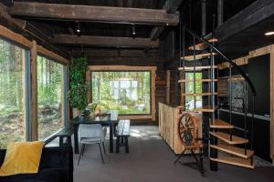 a living room with a table and chairs and windows at Elon ranta in Alvajärvi +20 photos