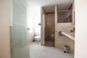 a bathroom with a toilet and a sink at La Casa Demi in Hetzerath +21 photos