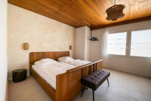 a bedroom with a bed and a bench in it at La Casa Demi in Hetzerath