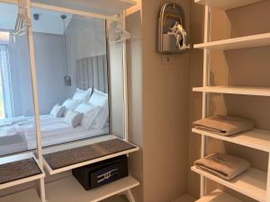 a bedroom with a mirror with a bed in it at Vista on the sea in Ankaran