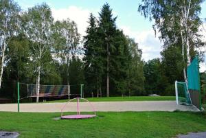 a park with a volleyball court with a net at Chatová Osada Pohádka in Vazačka