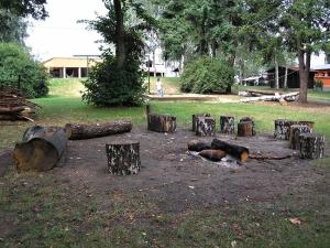 a group of logs sitting on the ground in a park at Chatová Osada Pohádka in Vazačka