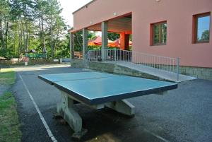 a ping pong table in front of a building at Chatová Osada Pohádka in Vazačka