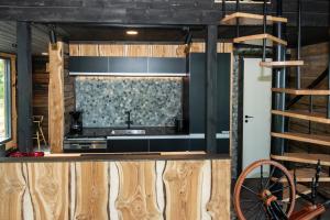 a kitchen with wooden walls and a stove top oven at Elon ranta in Alvajärvi