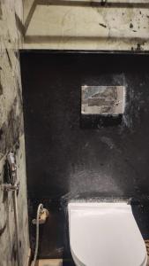 a bathroom with a white toilet in a room at Hotel bindu in Ghāzīpur