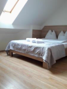 a bedroom with a bed with white sheets and pillows at Zajazd Zacisze in Żary