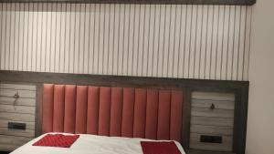 a bedroom with a bed with red and white sheets at Hotel bindu in Ghāzīpur