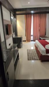 a bedroom with a bed and a desk and a sink at Hotel bindu in Ghāzīpur