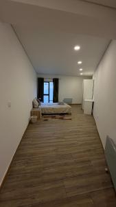 a large room with a bed in the middle of it at Quarto privado com banheiro no centro de Viseu in Viseu