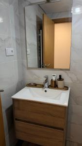 a bathroom with a white sink and a mirror at Quarto privado com banheiro no centro de Viseu in Viseu +7 photos