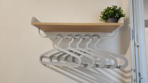 a row of strainer hooks on a wall at 338 House in Ban Liam