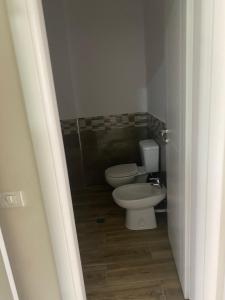 a bathroom with a toilet and a sink at ApartamentAbiBank in Elbasan +11 photos