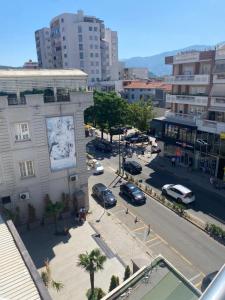 a city street with cars parked in a parking lot at ApartamentAbiBank in Elbasan