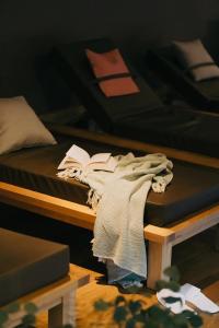 a bed with a blanket and a book on it at Das Tannberg in Lech am Arlberg +80 photos