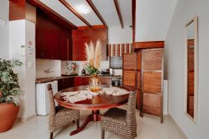 a kitchen with a wooden table and chairs at Ridgeworth Boutique Guesthouse in Bellville