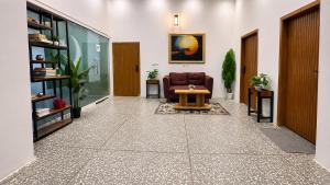 an office lobby with a couch and a table at Royal Palm Villa in Rawalpindi +1 photo
