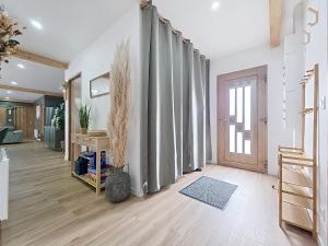 a living room with a hallway with curtains and a door at Les Piafs du Der 2 in Joncreuil +108 photos