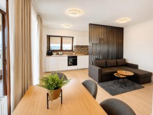 a living room with a couch and a table at Sea Gem Mamaia - 200m to Beach, XL Terrace, and Beautiful Views in Mamaia
