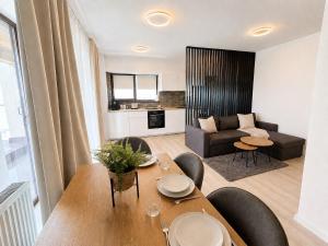 a living room with a table and a couch at Sea Gem Mamaia - 200m to Beach, XL Terrace, and Beautiful Views in Mamaia +24 photos