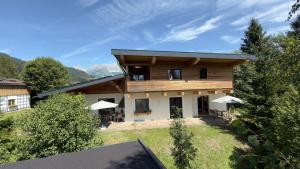 an exterior view of a house with trees at Appartements Skida in Reith bei Kitzbühel