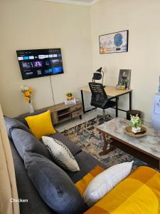 a living room with a couch and a table at LaDee Homes Cozy 1 bedroom in Kakamega - Old National Housing Estate in Kakamega