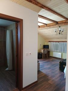 an open door to a living room with a table at Стаи за гости "Архангел Михаил" in Kostenets