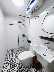 a bathroom with a white toilet and a sink at ROSE HOUSE Cat Ba island in Cat Ba +59 photos