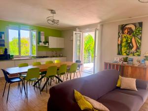 a living room with a couch and a table and chairs at Villa Bocciolo, piscina, giardino, vasca idromassaggio in Manerba del Garda