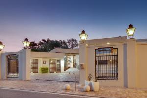 a house with a gate and lights on it at Ridgeworth Boutique Guesthouse in Bellville