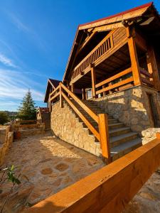 a building with a staircase in front of it at Chalet O Refúgio 2 in Penhas da Saúde