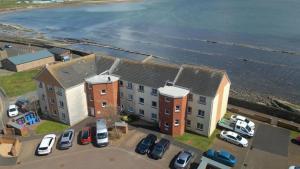 an aerial view of a building next to the ocean at Harbour Point Apartment in Saltcoats