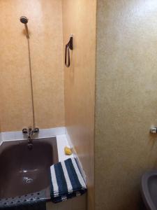a bathroom with a bath tub and a sink at Appartement calme in Eaux-Bonnes