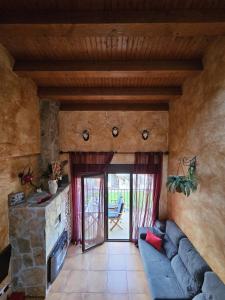 a living room with a blue couch and a stone fireplace at El Ático de Mijares in Mijares