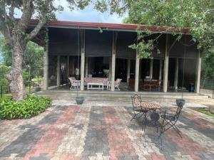 a patio with chairs and a table in front of a building at Kalan Digana in Digana