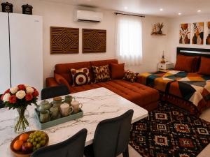 a living room with a couch and a table at La Dune Bohème chic in Saint-Maurice-de-Beynost